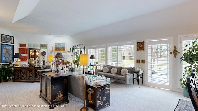 living area featuring light colored carpet and vaulted ceiling