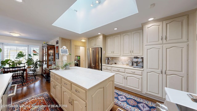 kitchen with light countertops, a skylight, and high end refrigerator