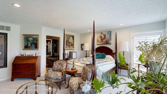 bedroom with recessed lighting, a textured ceiling, and visible vents