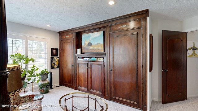 entryway with baseboards, light carpet, recessed lighting, and a textured ceiling