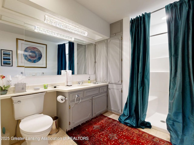 bathroom with vanity, tile patterned flooring, toilet, and a shower with curtain