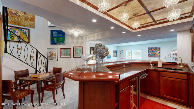 bar featuring a sink, light colored carpet, recessed lighting, and a notable chandelier