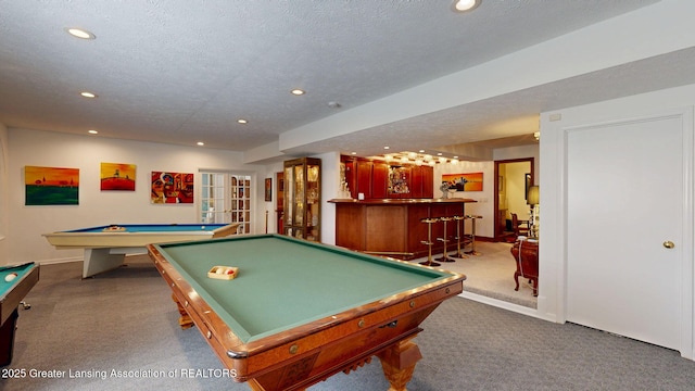 playroom with a textured ceiling, pool table, a bar, carpet, and recessed lighting