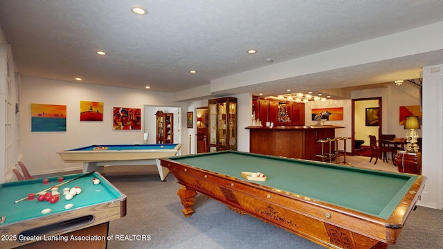 rec room with billiards, a textured ceiling, carpet floors, a bar, and recessed lighting