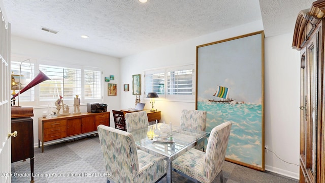carpeted dining room featuring visible vents, recessed lighting, a textured ceiling, and baseboards