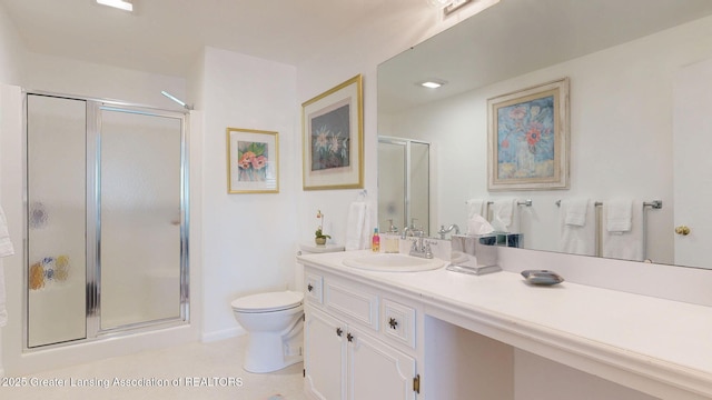 bathroom featuring vanity, toilet, tile patterned floors, and a stall shower