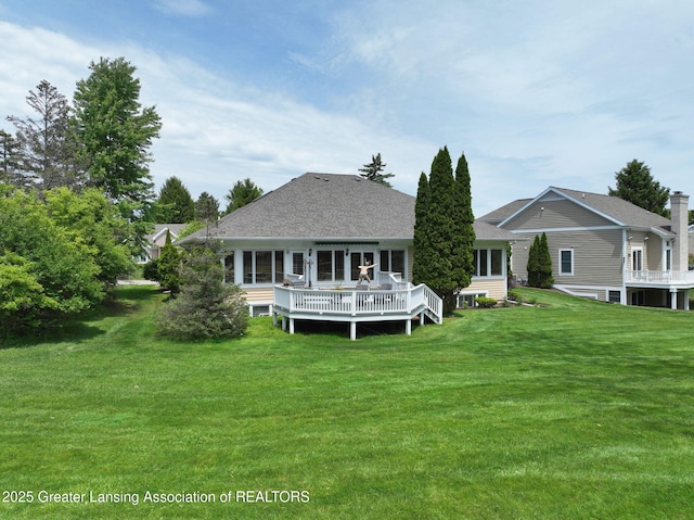 6074 E Longview Dr, East Lansing, MI 48823 - back of property featuring a yard, a deck, and roof with shingles