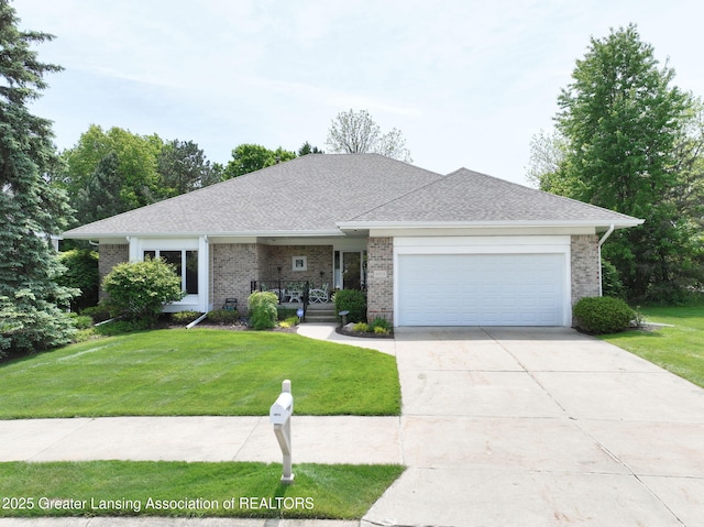 6074 E Longview Dr, East Lansing, MI 48823 - view of front facade featuring a front yard, an attached garage, covered porch, and brick siding