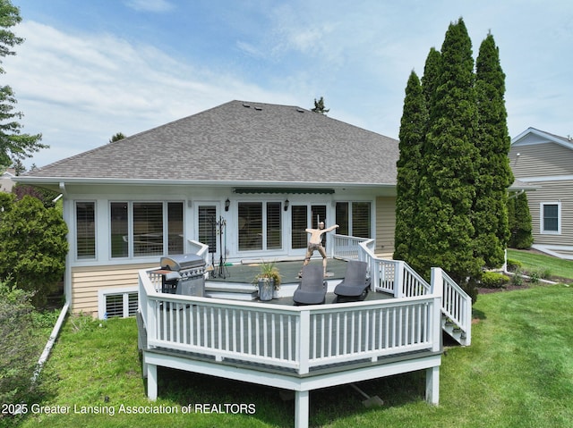 6074 E Longview Dr, East Lansing, MI 48823 - back of house with a shingled roof, a deck, and a lawn