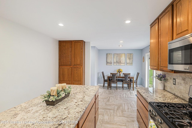 kitchen with recessed lighting, appliances with stainless steel finishes, and brown cabinets