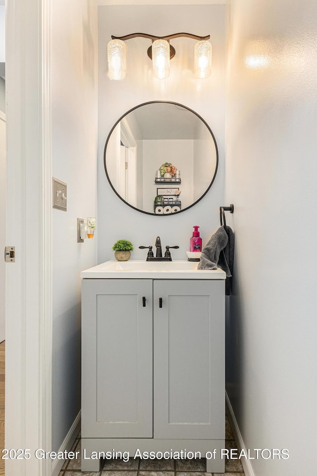 bathroom with baseboards and vanity
