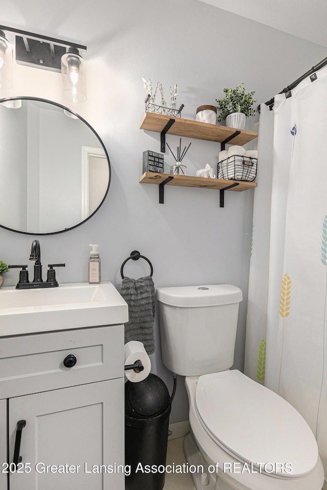 full bathroom with vanity, baseboards, curtained shower, and toilet