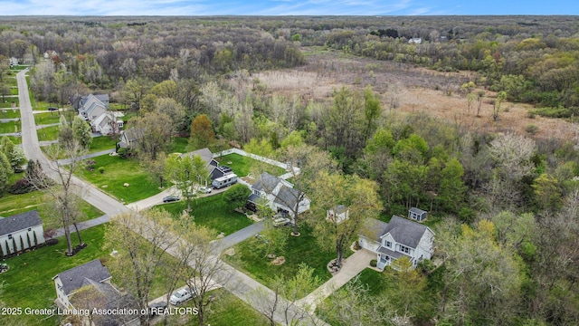 birds eye view of property with a residential view and a view of trees