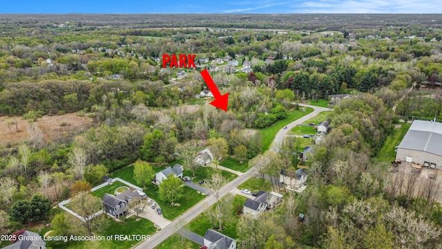 birds eye view of property with a wooded view