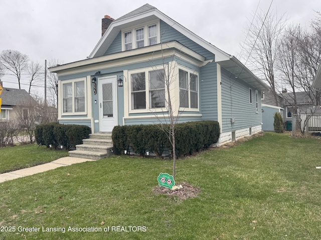 bungalow with a front yard and a chimney