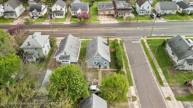 birds eye view of property with a residential view