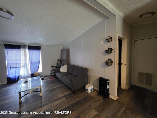 9304-9306 Parkhurst Hwy, Addison, MI 49220 - living room featuring visible vents, crown molding, heating unit, wood finished floors, and a textured ceiling