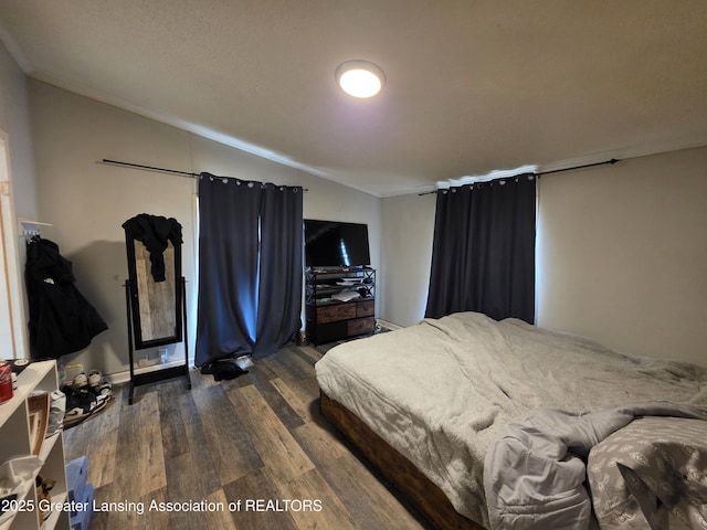 9304-9306 Parkhurst Hwy, Addison, MI 49220 - bedroom featuring dark wood-style floors, ornamental molding, and lofted ceiling