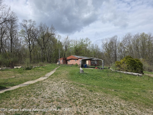 9304-9306 Parkhurst Hwy, Addison, MI 49220 - view of yard with a carport and a forest view