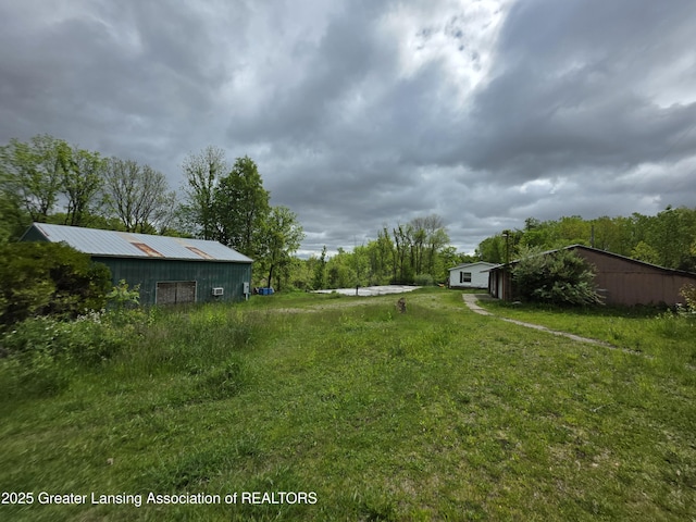 9304-9306 Parkhurst Hwy, Addison, MI 49220 - view of green lawn featuring an outbuilding and an outdoor structure