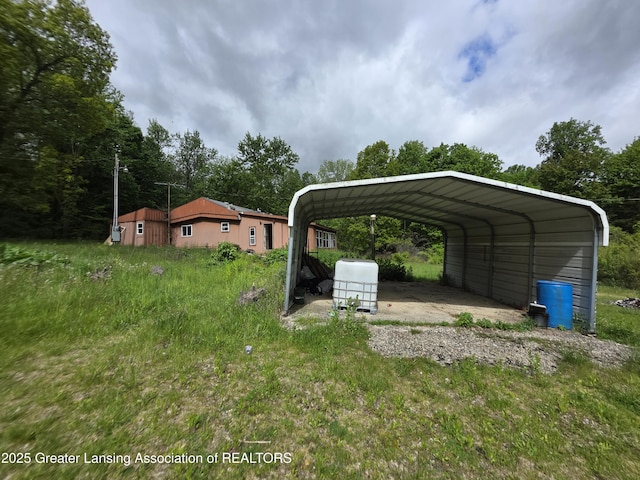 9304-9306 Parkhurst Hwy, Addison, MI 49220 - view of car parking with a carport and driveway