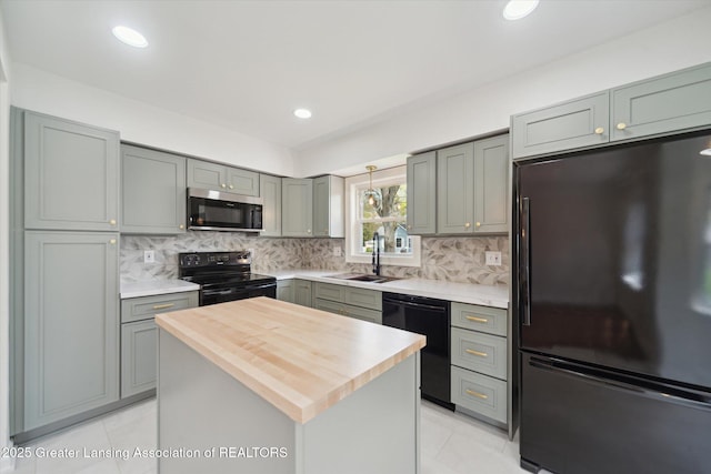 kitchen featuring a sink, black appliances, and gray cabinetry