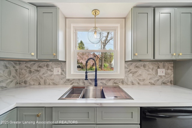 kitchen featuring a sink, pendant lighting, black dishwasher, and tasteful backsplash