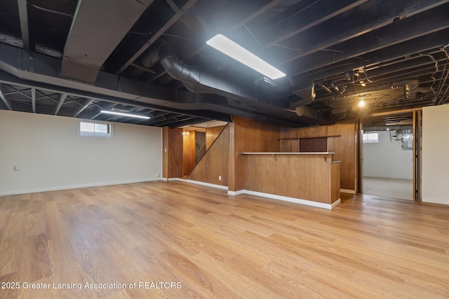 basement with wood finished floors and wooden walls