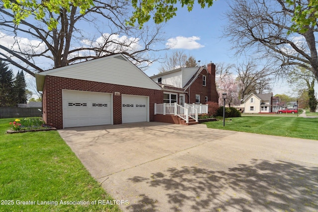 view of side of property featuring a garage, a chimney, brick siding, concrete driveway, and a yard