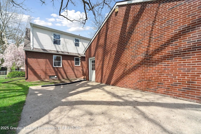 back of property featuring brick siding, a patio area, and fence