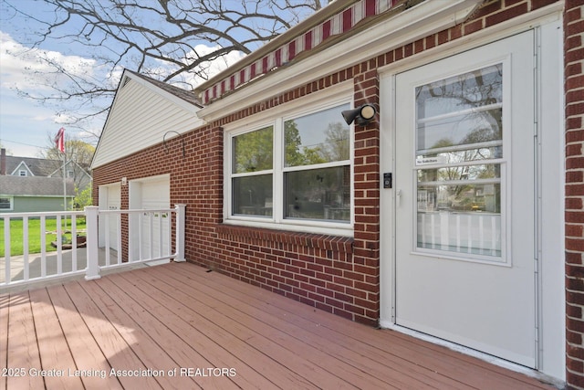 wooden deck featuring an attached garage