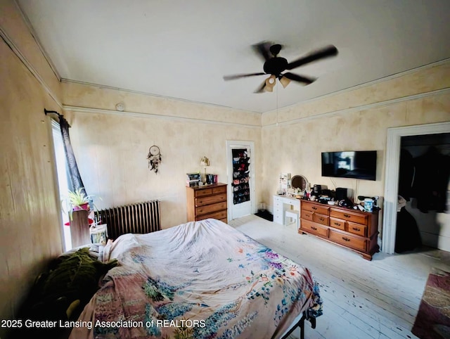 bedroom featuring radiator, ceiling fan, and hardwood / wood-style floors