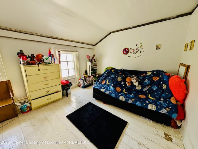 bedroom with crown molding, lofted ceiling, and hardwood / wood-style floors