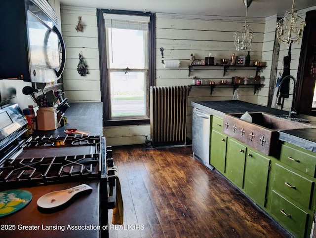 kitchen with green cabinetry, black microwave, radiator, gas range, and dark wood-type flooring