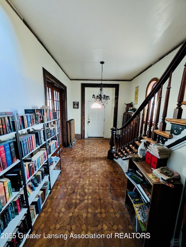 entryway with stairs and a chandelier