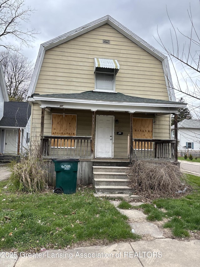 view of front of house with covered porch and a gambrel roof