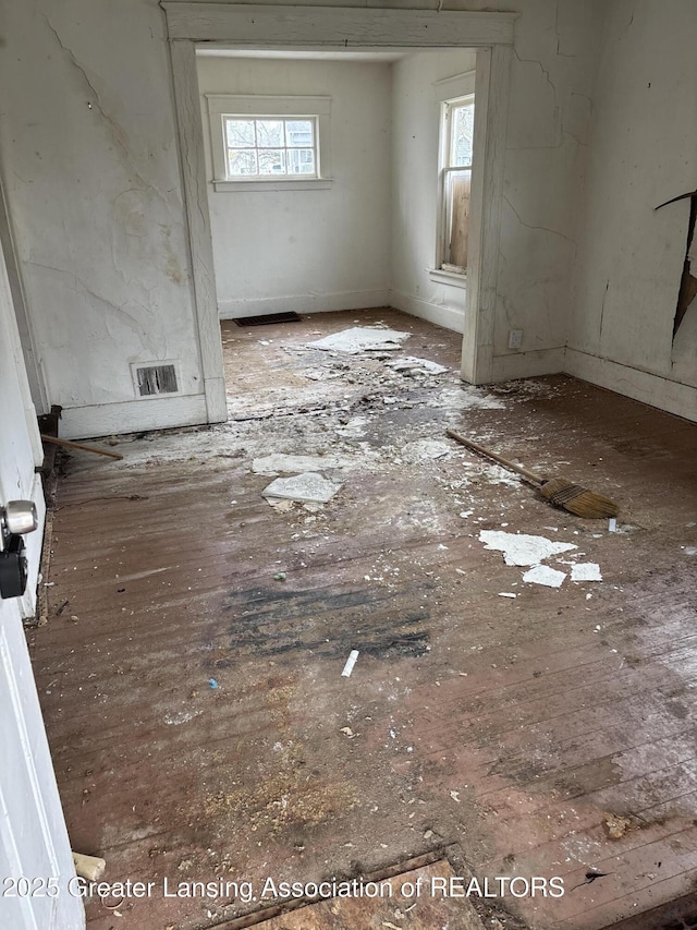 unfurnished room with visible vents