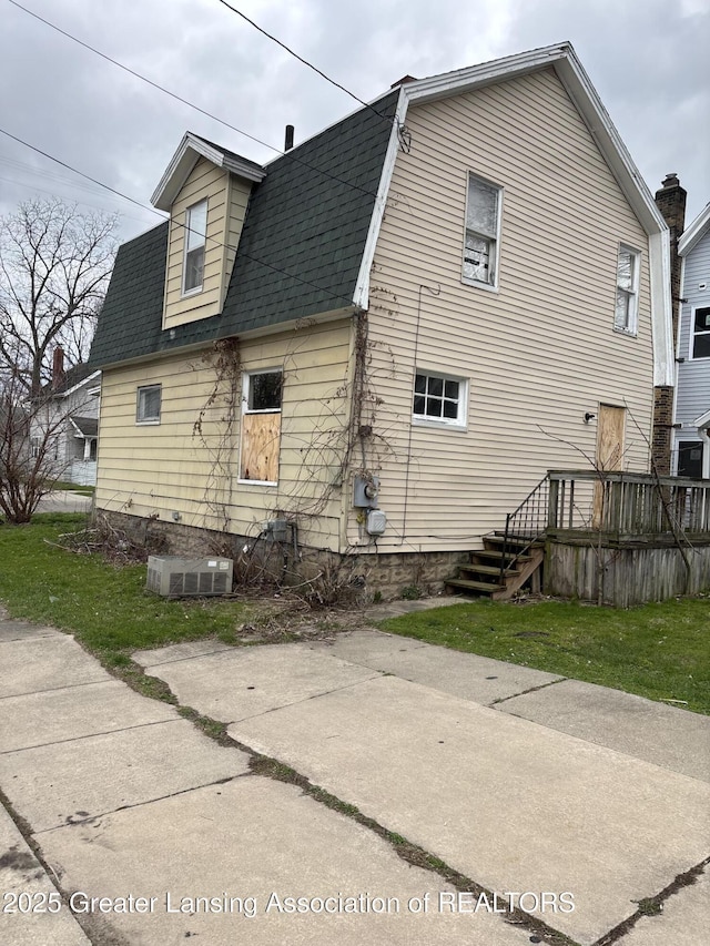 back of property featuring a shingled roof