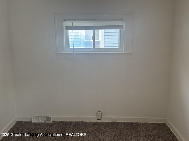 unfurnished room with carpet floors, baseboards, and visible vents