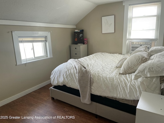bedroom with baseboards, cooling unit, lofted ceiling, and dark wood-type flooring