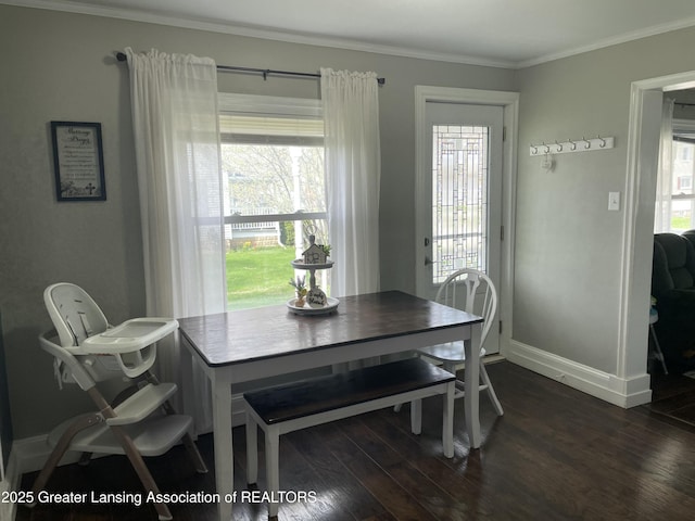 dining area with crown molding, baseboards, and dark wood-style flooring