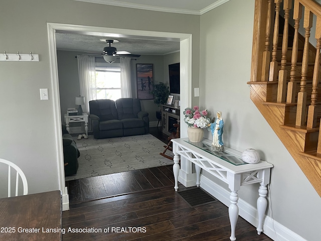 interior space with crown molding, baseboards, ceiling fan, and hardwood / wood-style floors