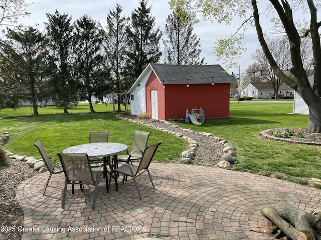 view of patio with an outdoor structure and outdoor dining area