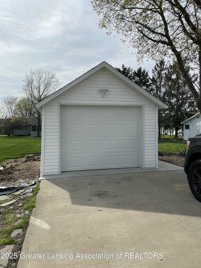 detached garage with concrete driveway