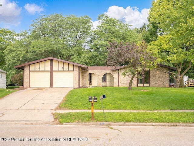 view of front of property with concrete driveway, a garage, and a front lawn