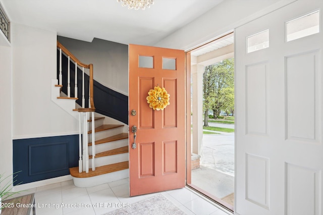 tiled foyer entrance featuring stairs