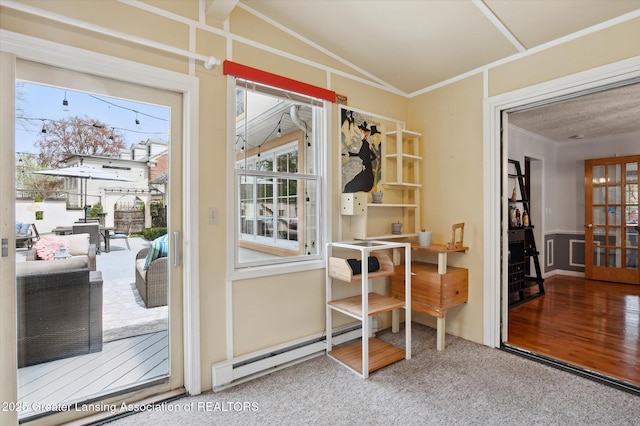 entryway featuring ornamental molding, carpet, and a baseboard heating unit