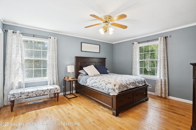 bedroom with ceiling fan, baseboards, ornamental molding, and light wood-style flooring