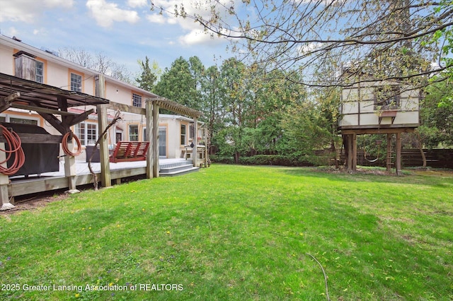 view of yard featuring a wooden deck and a pergola