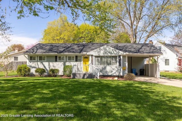 single story home featuring fence, an attached carport, concrete driveway, and a front yard
